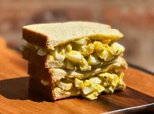 image of egg salad sandwich made with Bravado Spice Creamy Herb & Jalapeño Hot Sauce.