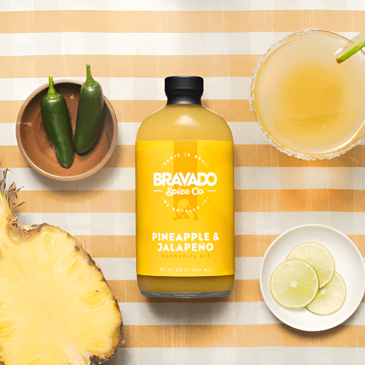 Bravado Spice Pineapple & Jalapeno margarita mix with fresh pineapple, jalapenos, and lime slices.