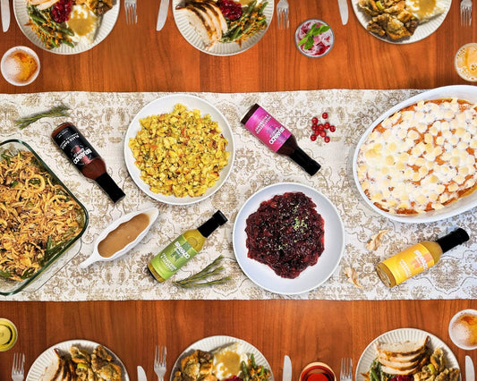 Bravado Spice Co’s Hot Sauces, placed on a table over a cloth around different dishes.